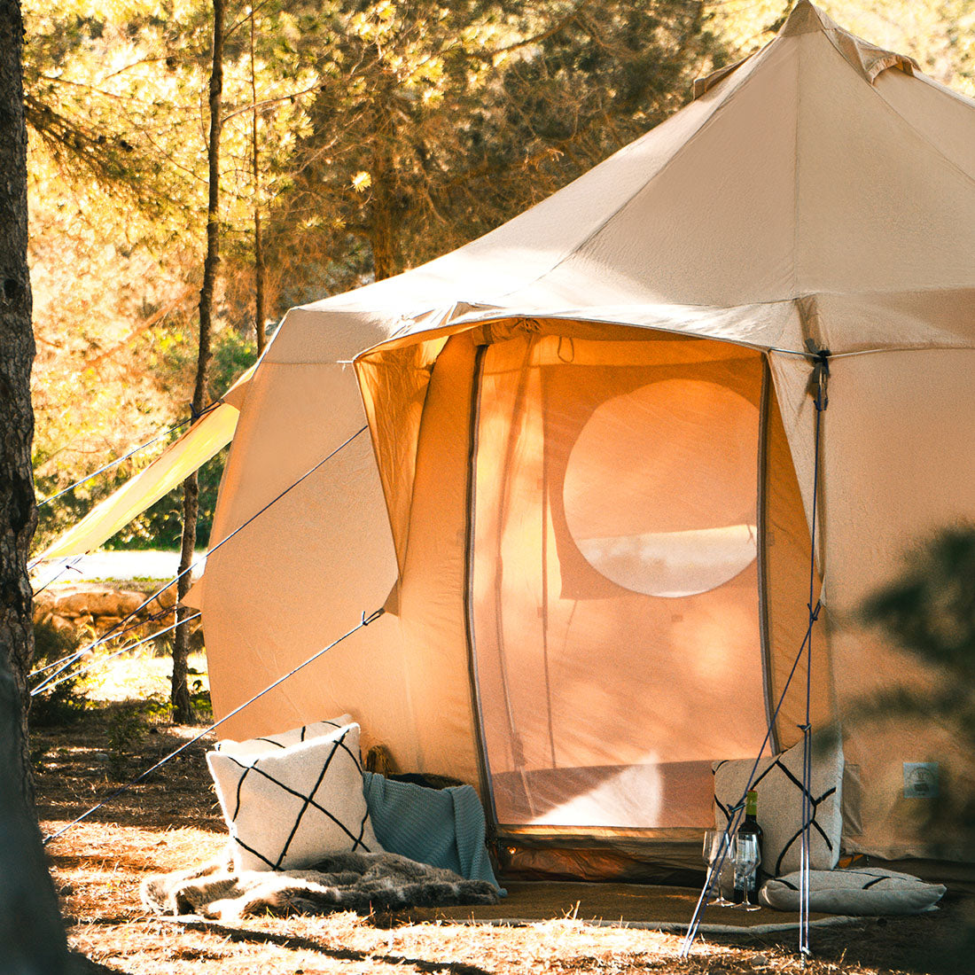 close up of a 4m luna bell tent in a forest