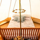 internal view of a 5m bell tent plus with a boutique camping chandelier and a bed