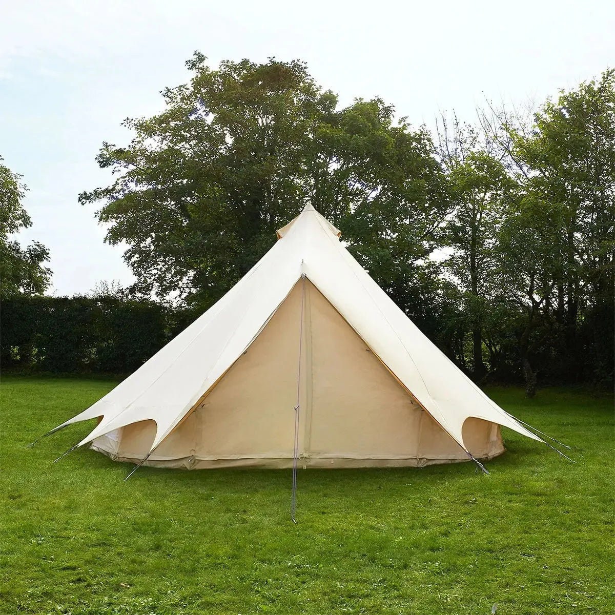 Beige Bell Tent Plus on grass with trees in the background