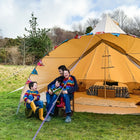 boutique camping star bell tent in a field with a family of triplets and their dad