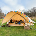 sandstone boutique camping 6m star bell tent with children playing inside featuring bunting and a chandelier