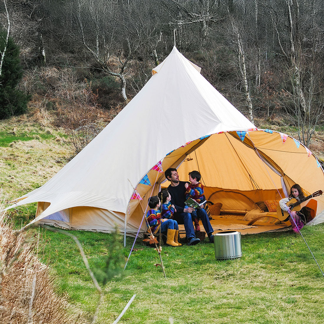 glamping star bell tent 6m with open door and a family enjoying themselves