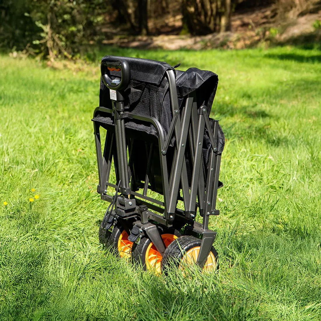 boutique camping electric camping wagon folded up in a green field