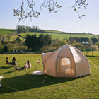 nova air dome glamping tent in a green field with children playing