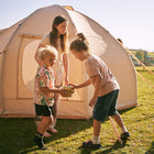 children sharing easter eggs in front of the boutique camping nova inflatable air tent