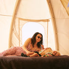 mum and son laughing on a bed inside the nova air dome tent