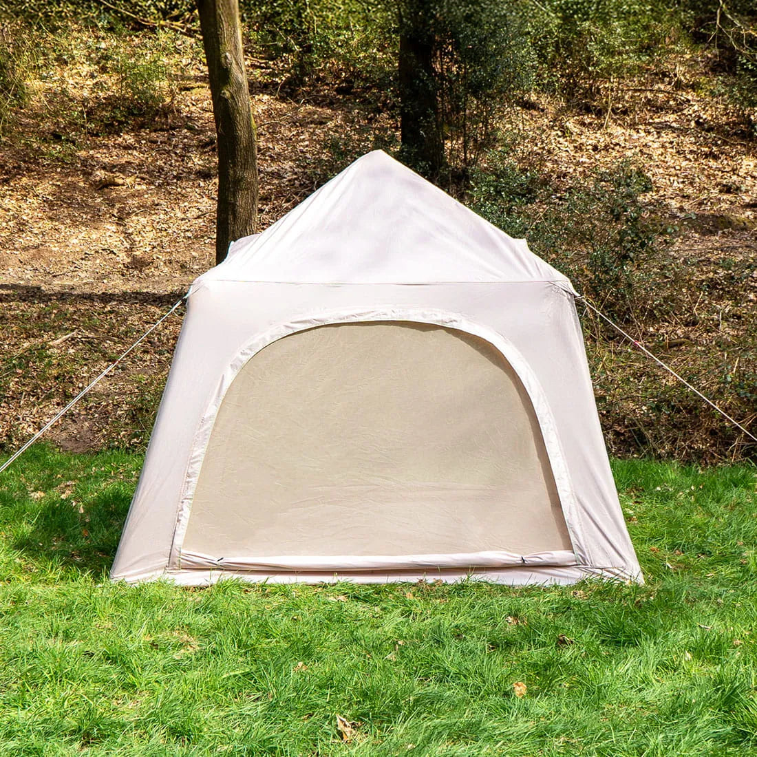 mesh windows shown of a boutique camping festival tent with trees in the background