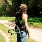 boutique camping bell tent backpack carried by girl in sunny field