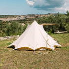 back view of the tucana tent situated on grass with trees and a blue sky