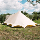 back view of the tucana tent situated on grass with trees and a blue sky