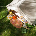 Vela Air Tent set in nature, featuring vibrant cushions and a cozy boho style – Glamping tent by Boutique Camping