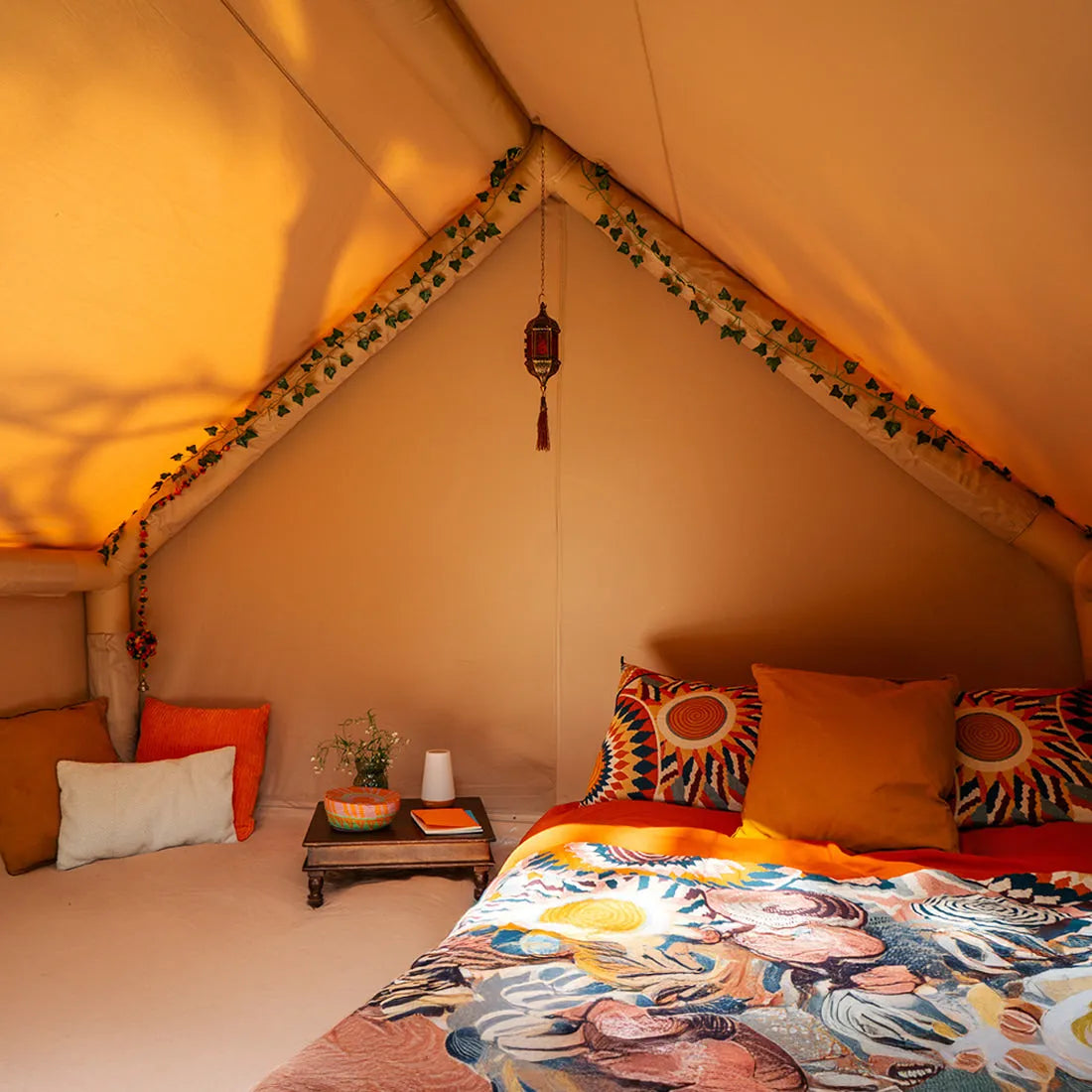 Interior view of Vela Air Tent showcasing colorful decor and bedding– Luxury glamping tent by Boutique Camping