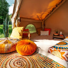 Interior of Vela Air Tent showcasing a mix of colorful cushions and a relaxed glamping vibe – Boutique Camping