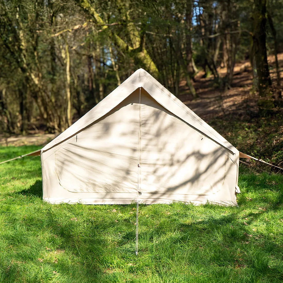 Vela Air Tent fully erected in a forest clearing, showing the clean design and sturdy airframe.