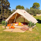boutique camping inflatable double door vela air tent with bohemian summery furnishings on a sunny day