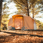 luna bell glamping tent with mesh door open in a forest with orange lighting