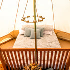 internal view of a 5m bell tent plus with a boutique camping chandelier and a bed