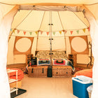 interior view of a boutique camping 5m luna bell tent with double bed and furniture