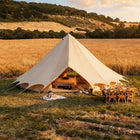 Bell tent plus glamping tent front view at sunset in open field