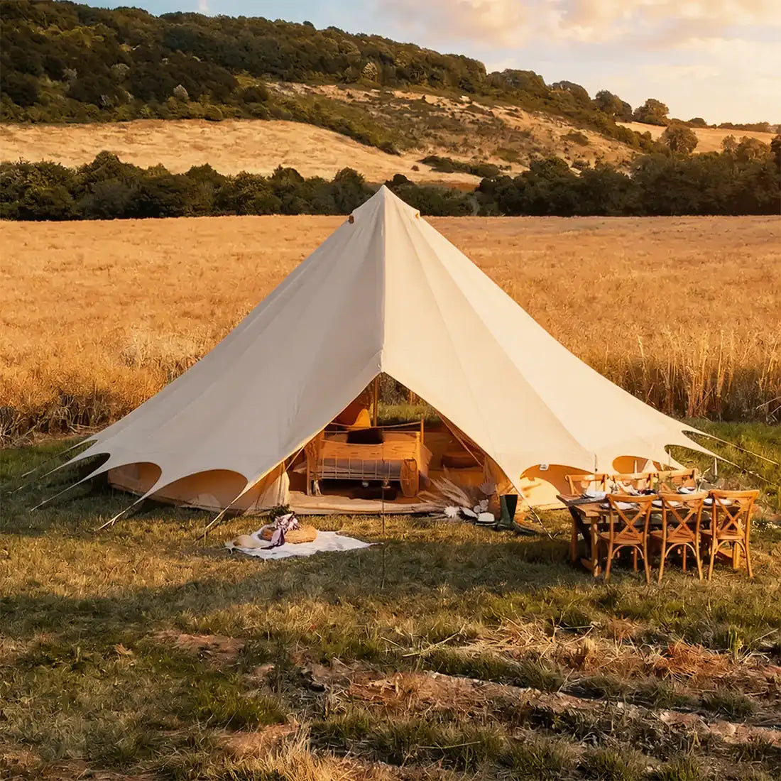 Bell tent plus glamping tent front view at sunset in open field