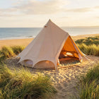 boutique camping 3m bell tent plus side view on a beach at sunset surrounded by grass