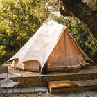 bell tent plus boutique camping glamping tent on a wooden platform surrounded by trees