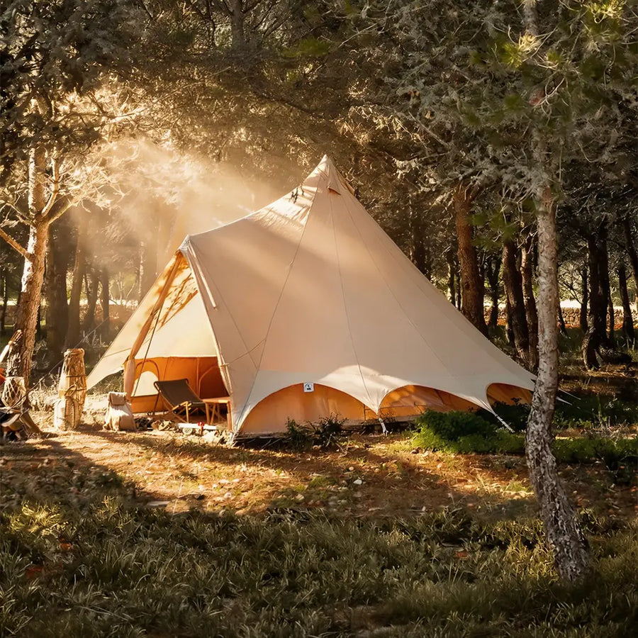 Bell tent plus glamping tent side view in forest at sunset