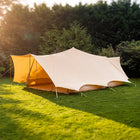 boutique camping tucana bell tent double door set up on grass with trees in the background 