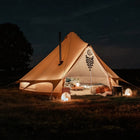 boutique camping bell tent plus glamping tent night time with stove flue