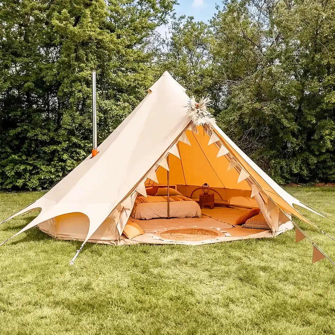 Bell tent plus glamping tent fire setup with stove flue side view in field