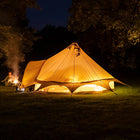 boutique camping star bell tent lit up at night time