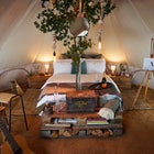 boutique camping star bell tent rustic interior with double bed glamping set up 