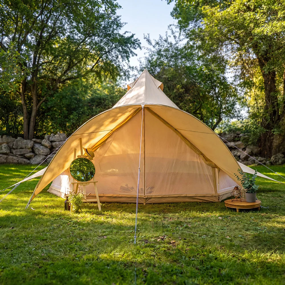 boutique camping star bell tent pitched on grass with mirror and subtle dressing