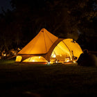 boutique camping star bell tent lit up at night