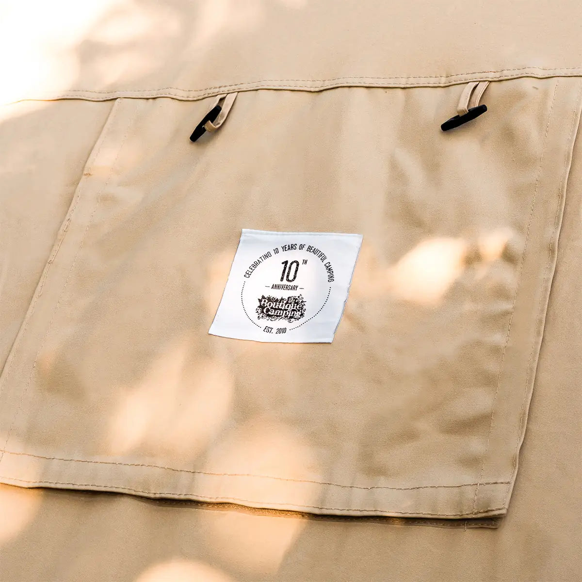 close up of boutique camping stove hole flap with hole in cotton fire retardant tent