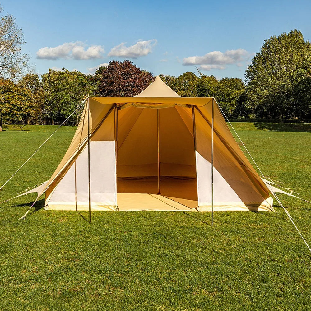 boutique camping tucana tent with open front door set up on a grassy field with trees in the background 