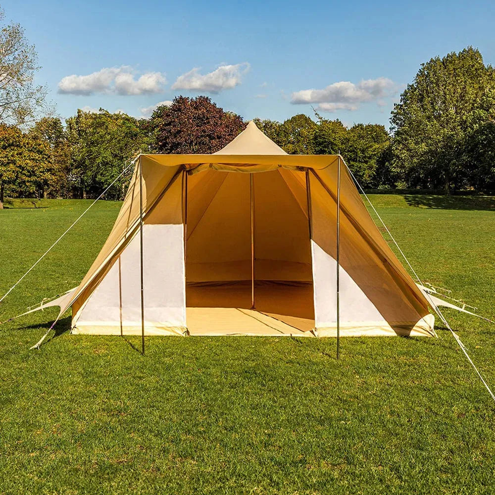 boutique camping tucana tent with open front door set up on a grassy field with trees in the background 