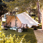 boutique camping large tucana bell tent set up in grassy area with outdoor furniture and decorations 