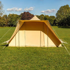 boutique camping tucana bell tent in a grassy field with trees in the background 