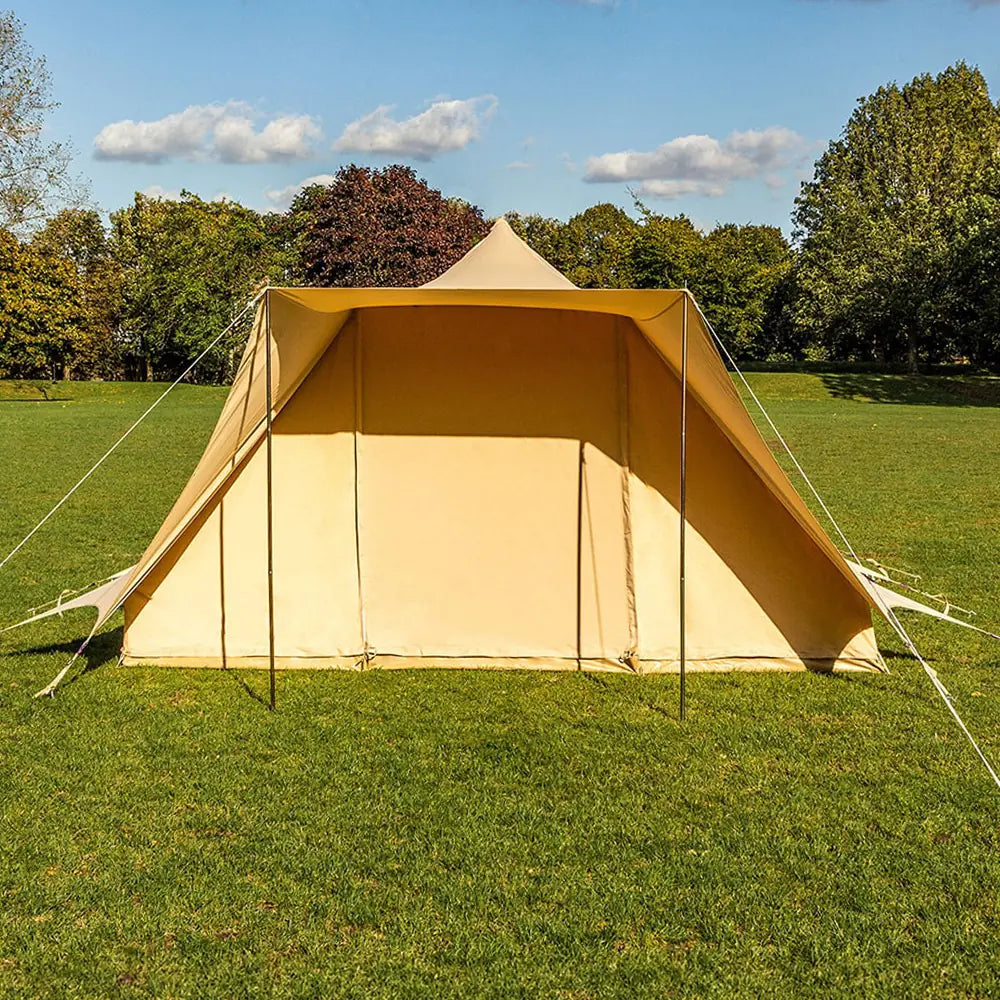 boutique camping tucana bell tent in a grassy field with trees in the background 