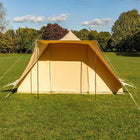boutique camping tucana bell tent in a grassy field with trees in the background 
