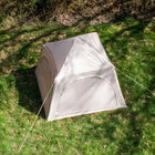 aerial shot from above of boutique camping sandstone stellar tent with shadows on tent from trees 