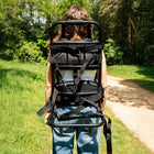 girl carrying an empty boutique camping back pack 