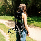 boutique camping bell tent backpack carried by girl in sunny field 
