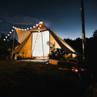 A boutique Tucana tent glows warmly under a star-filled night sky, its soft illumination contrasting with the deep blue expanse above