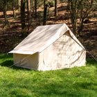 Vela Air Tent pitched solo in a peaceful woodland area, surrounded by trees and dappled sunlight.
