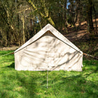 Vela Air Tent fully erected in a forest clearing, showing the clean design and sturdy airframe.